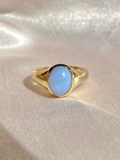 10k yellow gold baby blue chalcedony cabochon signet ring handmade to order by 23carat. This is a solid signet ring at 5.85 grams, with an oval cut natural chalcedony gemstone. New production Size: 7 resizable Weight: 5.85 grams Chalcedony: 10x8mm oval cut blue cabochon, ~ 2.15cts Width: 4.2mm (front), 2.8mm (back) Handmade to order, please allow for approximately 1 to 3 weeks before shipping For more details or customization options, emails us at info@shop23carat.com Hippy Fits, Jewellery Wishlist, Study Core, Blue Chalcedony Ring, Chalcedony Ring, Cabochon Ring, Wire Rings, Gold Baby, Handmade Rings