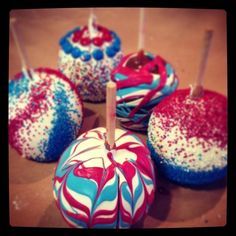 red, white and blue cake pops on a table