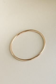 The Georgia Bangle is modern yet timeless—a minimalist bracelet featuring an organic oval shape, designed for constant wear. It is comfortable enough for sleep and sport, and strong enough to gracefully withstand decades of daily use. Each hand-soldered bracelet is shaped to mimic the contours of your forearm. Available in durable 14k gold fill, solid sterling silver, and solid 14k or 18k gold, these materials are solid (not hollow), water-resistant, and low maintenance. This bangle is truly mad Soldered Bracelet, Gold Bracelet Design, Dainty Fine Jewelry, Minimalist Bangle, Modern Gold Jewelry, Instagram Jewelry, Casual Jewelry, Stylish Bracelet, Bracelet Style