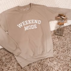 Tan sweatshirt with white Weekend Mode text .  All sweatshirts are personally designed and heat pressed on high quality Gildan sweatshirts. 50/50 cotton/poly, heavyweight, tear away label and machine washable. Unisex sizing, therefore these run large but give a perfect oversized vibe. Size down if you prefer a smaller fit. Check the size chart for reference.  Your item is handmade with love, therefore please treat it with love. It is recommended to wash inside out and dry on low heat/hang to dry for best long-term results.  Please allow 1-2 weeks for delivery. No returns or exchanges, but please contact me if you have any problems with your order. Trendy Crew Sweatshirt For Loungewear, Oversized Comfortable Sweatshirt With Graphic Print, Trendy Crew Neck Sweatshirt For Loungewear, Trendy Crew Sweats For Loungewear, Relaxed Fit Sweatshirt For Spring Weekend, Spring Weekend Long Sleeve Sweatshirt, Trendy Crew Cotton Sweats, Oversized Graphic Print Sweatshirt For Weekend, Trendy Relaxed Fit Sweatshirt For Loungewear