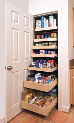 an organized pantry in a kitchen with lots of food on the shelves and under the door