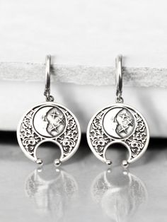 Embrace the mystique of the moon with these stunning half moon earrings. Handcrafted from high-quality sterling silver, these lunula earrings feature an intricate design inspired by Viking jewelry and celestial themes. Perfect for those who love boho style and lunar symbolism, these earrings capture the beauty and mystery of a lunar eclipse. These sterling silver lunula earrings are both elegant and durable, making them ideal for everyday wear or special occasions. The detailed craftsmanship reflects the timeless appeal of Viking jewelry while adding a modern boho twist. Whether you're looking for a unique accessory or a thoughtful gift, these half moon earrings are a perfect choice. Celebrate the celestial charm and Viking heritage with these exquisite half moon earrings. Their handcrafte Bohemian Crescent Sterling Silver Earrings, Bohemian Sterling Silver Crescent Earrings, Celestial Moon-shaped Pierced Cartilage Earrings, Celestial Moon Shaped Pierced Cartilage Earrings, Celestial Sterling Silver Earrings, Symbolic Moon Charm Earrings, Silver Moon Shaped Symbolic Jewelry, Celestial Silver Pierced Jewelry, Symbolic Silver Moon-shaped Jewelry