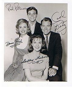 an old black and white photo of four people with signed autographs on the back