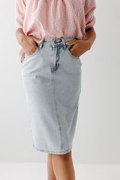 The 'Kyra' is another one of our very own exclusive denim skirts. Designed with everyday wear in mind, this skirt will pair well with just about any casual top in your wardrobe! This denim skirt is 100% cotton and does not have stretch, giving it a vintage vibe we love! Every woman needs a classic, straight denim skirt in her closet and this skirt is an excellent choice! Available in light or vintage wash. 100% Cotton Machine Wash Cold Gentle Cycle Do Not Bleach Hang to Dry Do Not Dry Clean Mode Spring Denim Blue Cotton Skirt, Spring Cotton Denim Skirt, Spring Medium Wash Denim Midi Skirt, Trendy Denim Blue Midi Skirt, Spring Cotton Mid-rise Skirt, Spring Mid-rise Cotton Skirt, Trendy Denim Midi Skirt, Summer Cotton Skirt In Medium Wash, Trendy Relaxed Fit Denim Skirt