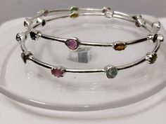 Beautiful Silver bangles exquisitely crafted by hand and designed with love. Genuine Handmade Tourmaline Bangle 925 Sterling Silver Flower Bangle-Multi Tourmaline Flower Bangles-Gemstone Bangle-multi Tourmaline Bangle > sold By 2 Piece PRODUCT DETAILS :- > Material - 925 Sterling Silver > Gemstone - Pink Tourmaline (100 %real ) > Gemstone shape - Oval > Gemstone Weight - 6.30 Ct > Gemstone Size- 4.6 mm > Setting - Pave setting > Gross Weight- 10.60 Grams Production Time: Each of our pieces are m Round Stackable Tourmaline Jewelry, Stackable Round Tourmaline Jewelry, Multicolor Gemstone Bangle, Tourmaline Birthstone Jewelry, Silver Tourmaline Adjustable Jewelry, Adjustable Silver Tourmaline Jewelry, Silver Bangles Design For Women, Silver Bangles Design For Women Indian, Silver Bangles Design