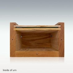 the inside of an empty wooden box on a white surface with text above it that reads inside of urn