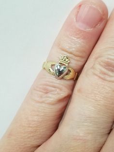 "Thanks for shopping our vintage estate store. We tend to sell well below wholesale and truly hope you enjoy all of our items. Many of the items are one of a kind, so please enjoy scrolling through the pictures and hopefully something will catch your eye. Blacks spots are from camera or reflections. Beautiful estate 14k gold yellow white gold Irish Claddagh infant or baby ring. Retails $299 on sale $149 Ring size: 1 Setting: 3/8\" 8.5mm Band width: 2mm Weight: .1.07 grams Beautiful ring, one tha Collectible 14k Gold Heart-shaped Jewelry, Heart Cut Hallmarked Collectible Jewelry, Classic Heart Jewelry For Collectibles, Collectible Heart Cut Gold Jewelry, Gold Heart Cut Collectible Jewelry, Classic Heart-shaped Collectible Jewelry, Classic Heart Shaped Collectible Jewelry, Vintage 14k Stamped Heart Cut Jewelry, Heirloom 14k Stamped Jewelry For Anniversary