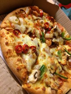 a pizza sitting in a box on top of a table