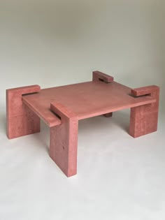 a table made out of red clay with one section missing from the top and another part missing from the bottom