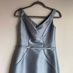 a blue dress hanging on a hanger