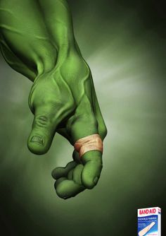 a green hand with a bandage on it's wrist holding something in the air