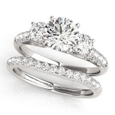 an engagement ring and wedding band set with round brilliant cut diamonds on the side, in white gold