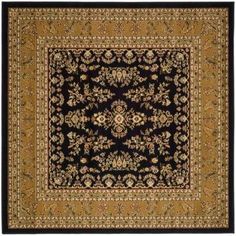 a black and gold rug with an ornate design on the center, surrounded by flowers