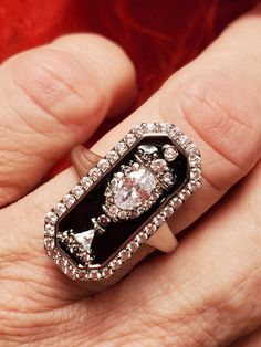 This is an absolutely amazing silver plate over brass with black enamel ring.  The enamel is painted around clear CZ stones in an urn motif.  You see this style in the 18th and 19th centuries usually as a memento mori or mourning ring.  Perfect for those who love historical pieces at an affordable price.  This ring reminds me of one that Marie Antoinette wore. It measures 1 inch tall by 1/2 inch wide and is so sparkly.  Limited stock at the moment.  Drop down has the sizes in stock.    If I do n Formal Silver Enamel Rings, Black Enamel Jewelry For Wedding, Black Enamel Wedding Jewelry, Victorian Black Enamel Rings For Anniversary, Victorian Black Enamel Anniversary Rings, Victorian Black Enamel Wedding Rings, Black Enamel Ring For Anniversary, Formal Silver Ring With Black Enamel, White Gold Ring With Black Enamel For Gift