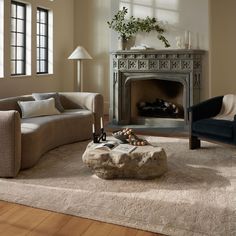 a living room with two couches and a fire place in it's center