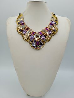 Each piece of our statement necklaces is handmade and one of a kind made in Italy. Our creations is made of high quality materials such as crystals and rhinestones. Each embroidered material is carefully hand sewn. Very glamorous and stylish. Perfect gift to someone you like. Materials Strass stone and Rhinestone in Violet, Crystal Golden Shadow and Violet Blue color in different dimension.  Black satin fabric backing. Aluminium chain with lobster closure. Measurements Weight approximate 200 grams. Chain lenght 25 cm - 9.84 in Circumference approximate 63 cm - 24.80 in Feel free to contact us if you have any question. Thank you so much for looking at our shop and our articles each of them, single piece. Crystal Jeweled Necklaces For Celebration, Luxury Crystal Necklaces With Jewels, Luxury Jeweled Necklaces For Celebration, Luxury Crystal Necklace With Jewels, Luxury Handmade Multicolor Necklaces, Luxury Handmade Multicolor Necklace, Luxury Rhinestone Necklaces For Parties, Party Pendant Necklaces With Jewels, Pendant Necklaces With Jewels For Parties