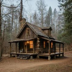 a small log cabin in the woods at dusk