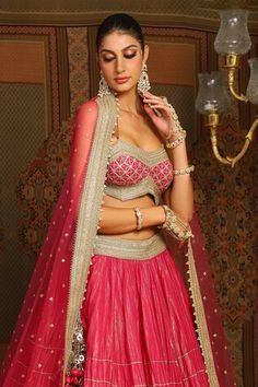 Rani pink lehenga featuring stacked style striped gota wave embroidery and heavy tassel ornamentations. Paired with a noodle strap blouse with geometric gota jaal embroidery and a heavily embellished floral border net dupatta., Fit: Relaxed Pink Wedding Sets With Cutdana Detailing, Party Pink Choli With Motifs, Pink Party Choli With Motifs, Elegant Pink Sets With Motifs, Pink Lehenga With Motifs For Navratri, Elegant Pink Lehenga With Motifs, Pink Traditional Wear With Motifs For Wedding, Elegant Pink Choli With Motifs, Pink Traditional Wedding Wear With Motifs