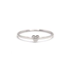 Engrave your initial with a loved ones initial onto this modern tiny heart ring. It's perfect as a couples and friendship gift. Please write the 2 initials you would like to engrave on the Notes box in the Shopping Cart. .925 Sterling Silver Laser Engraving Hypoallergenic, lead and nickel free Heart Height 3.5mm Band 1mm #R108 Heart Couple, Jewelry Gift Guide, Moms Bracelet, Choker Pendant, Yellow Gemstones, Gold Statement Ring, Studded Necklace, Nose Jewelry, Tiny Studs