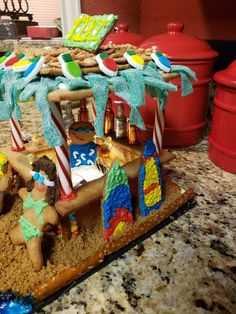 there is a cake made to look like a beach scene with people on the sand