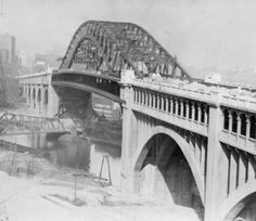 an old black and white photo of a bridge