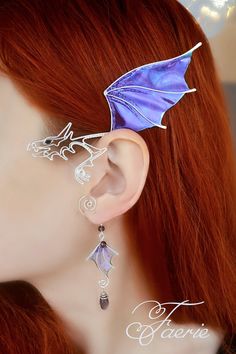 Purple dragon ear cuff with a small pendant crafted in silver plated wire and angelina film that sparkles magically in the sunlight. The film is very iridescent, so the color may vary depending on viewing angle and lightning. The ear cuff is very easy to wear. It is designed to hook over the back of your ear like a Blue Tooth device and can be gently shaped to perfectly fit your ear. No piercing needed. It's very light in weight. This magic ear cuff looks gorgeous either with short or long hair. Violet Dragon, Wing Ear Cuff, Dragon Ear Cuffs, Dragon Wing, Elf Ear Cuff, Fairy Ears, Blue Tooth, Dragon Earrings, Wrap Earrings