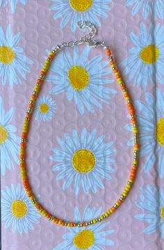 This is a sunrise colored necklace worn around the neck Yellow Necklaces With Colorful Beads For Summer, Yellow Round Bead Necklaces For Summer, Trendy Yellow Beaded Chain Necklace, Trendy Yellow Necklace With Beaded Chain, Handmade Yellow Beaded Bracelets For Summer, Yellow Beaded Chain Necklaces For Summer, Yellow Round Beads Jewelry For Summer, Yellow Beaded Necklace For Summer Gifts, Trendy Handmade Yellow Beaded Necklace