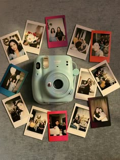 polaroid camera surrounded by many photos on the floor with one being used as a photo booth