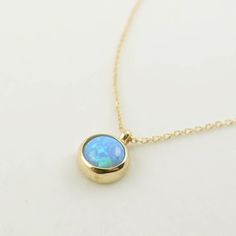 "\"Blue Opal Necklace | Opal Gemstone Pendant | Minimal and Elegant Gold Necklace for Daily Use | Anniversary Valentine Gift | Gift for Her\" In the Middle Ages, opal was considered a stone that could provide great luck because it was believed to possess all the virtues of each gemstone whose color was represented in the color spectrum of the opal. It was also said to grant invisibility if wrapped in a fresh bay leaf and held in the hand. This minimal necklace is a perfect minimal gift for your Opal Birthstone Necklaces, Opal Birthstone Round Necklaces, Round Opal Birthstone Necklaces, Fine Jewelry Opal Round Necklaces, Tarnish Resistant Opal Jewelry For Gifts, Tarnish Resistant Opal Jewelry Gift, Elegant Round Opal Necklace, Tarnish-resistant Opal Jewelry Gift, Opal Gemstone Round Pendant Necklace