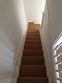 a set of stairs leading up to the top floor in a house with carpeted steps