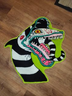 an animal rug with a zebra's mouth and teeth on top of the floor