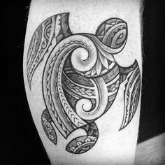 a black and white photo of a tattoo design on the thigh, with an image of a turtle