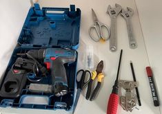 tools are laid out on a table with some screwdrivers, pliers and other items