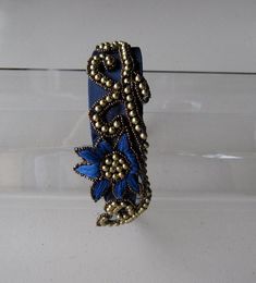 This Royal Blue Gold Beaded Flower Satin Headband is a beautiful accessory for weddings, parties, and other special occasions. It is elegant, unique, ornate, and super chic! A truly exquisite piece that will definitely add a special touch to your outfit!!I only accept PayPal and ship all orders within 24 hours via USPS.Feel free to send me a convo with any questions.Thank you for visiting Hettie Hair Accessories! Elegant Flower Hair Accessories With Handmade Flowers, Elegant Flower-shaped Hair Accessories With Handmade Flowers, Elegant Flower Hair Accessories For Gift, Elegant Handmade Flower Hair Accessories, Handmade Flower Headpiece For Wedding, Elegant Crown Hair Accessories For Parties, Elegant Embellished Crown Headpiece, Elegant Headband Hair Accessories As Gift, Elegant Handmade Headband For Party