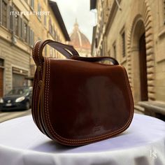 This bag has been made of the best genuine leather by local master crafters of Florence in Italy, designed for women who only accept premium Italian quality and luxury leather bags and modern Italian fashion. . . . Sizes: Width:   26cm/10.25inch Height:  18 cm/7 inch Depth:    9cm/3.6 inch The story of this bag: Alessandro was on a mission to find the perfect gift for his girlfriend's upcoming anniversary. He wanted to surprise her with something special, something that would show her how much he cared. He knew she loved fashion and always admired the beautiful leather bags made in Florence. He thought it would be the perfect gift, but with so many options to choose from, he was feeling overwhelmed. He scoured the shops, but couldn't seem to find the right one. One day, he stumbled upon a Elegant Cognac Saddle Bag With Smooth Grain, Elegant Brown Saddle Bag With Smooth Grain, Luxury Bridle Leather Satchel Shoulder Bag, Elegant Bridle Leather Bag For Daily Use, Luxury Smooth Leather Saddle Bag, Luxury Bridle Leather Rectangular Shoulder Bag, Elegant Bridle Leather Rectangular Bag, Italian Leather Bag As Gift, Italian Leather Bags In Cognac Color