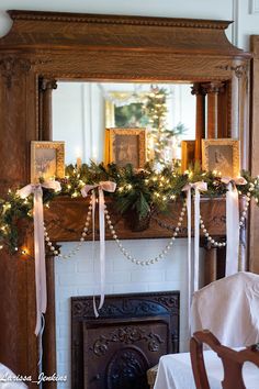 a mantel decorated for christmas with garland and lights