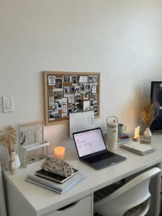 a laptop computer sitting on top of a white desk