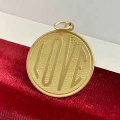 a gold medal sitting on top of a red cloth