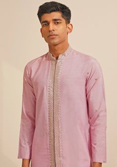 Featuring a stylish Lilac Silk Kurta Set, this ensemble includes a button-down kurta designed with a Chinese collar and a hidden placket. The hand-embroidered details on Kurta add a touch of grace and sophistication. Teamed with elegant white pants, this kurta set combines traditional elegance with contemporary style. Perfect for special occasions like Mehendi or Sangeet. Composition : Chanderi Silk Care: Dry Clean Only and Vacuum Storage This product can be customized for sleeves, length and colour Delivery : 4-6 weeks as the product is hand crafted. Check Size Guide or choose MySize for free customisation (All Sizes above XL can be made at 15% additional cost) For more information and sizes please contact fabiliciousfashion@gmail.com or visit our Copenhagen studio. About the Designer : S Silk Kurta Set, Chinese Collar, Vacuum Storage, Indian Wedding Wear, Silk Kurta, Embroidered Details, Kurta Designs, Kurta Set, White Pants