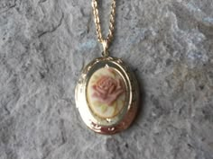 Beautiful cameo locket!!!  The cameo is a gorgeous Rose, choose pink or brown, many other styles and colors available in my shop, so please do browse!!!  The locket is gold plated, victorian style with beautiful scroll on the front and back.  It can hold two photos, keepsakes, or even your daily medication or vitamins!!! The chain is 20" gold plated link chain with a lobster claw clasp!!! Perfect  for Brides or Bridal parties.  Makes a unique memorable gift for any occasion!!!  Timeless classic Unique Locket Necklace Vintage, Cute Necklace Gold, Flower Locket Necklace, Vintage Rose Necklace For Wedding, Vintage Pink Jewelry For Keepsake, Vintage Pink Keepsake Jewelry, Vintage Rose-colored Jewelry For Gifts, Vintage Rose-colored Jewelry For Weddings, Vintage Rose Wedding Jewelry