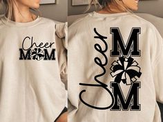 a woman wearing a shirt that says cheer mom and has a bow on the back