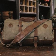 Dakota Vintage Travel Duffle Bag - Field Khaki Practical Travel Bag With Adjustable Strap For Overnight Trips, Functional Leather Duffle Bag For Outdoor Activities, Outdoor Satchel Duffle Bag With Adjustable Strap, Outdoor Duffle Bag Satchel With Adjustable Strap, Canvas Satchel Bag For Adventure, Canvas Satchel For Adventure, Functional Waxed Finish Bag For Overnight Trips, Travel Satchel Bag For Outdoor Activities, Outdoor Travel Satchel With Leather Handles