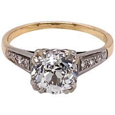 Vintage 1940s 14KY Gold and Platinum 1.56ct European Cut Diamond Engagement Ring - The center European Cut diamond weighs 1.56ct with J color and VS1 clarity. The diamond sits proudly in a platinum fishtail head. The setting has 3 single cut diamonds graduating in size on either side of the center diamond with a total approximate weight of .06ct. A fine milgrain edge surrounds the side diamonds. The platinum is perched on top of a simple 14k yellow gold band. The ring is a size US 6.25 and can b Luxury Victorian Diamond Ring With Single Cut Diamonds, Vintage Yellow Gold Cushion Cut Diamond Ring, Classic Yellow Gold Cushion Cut Diamond Ring, Classic Cushion Cut Yellow Gold Diamond Ring, Classic Collectible Diamond Ring With Vvs Clarity, Vintage Cushion Cut Rings For Formal Occasions, Vintage Cushion-cut Rings For Formal Events, Classic Collectible Diamond Ring With Center Stone, Vintage Platinum Diamond Ring In Yellow Gold