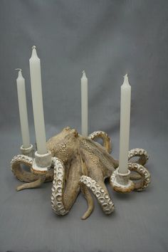 an octopus candle holder with five candles in it