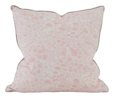 a pink and white pillow with an animal print pattern on the front, sitting on a white background