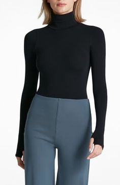 This buttery-soft turtleneck top fits like a second skin thanks to ample stretch that's blended right in. Turtleneck Long sleeves 84% nylon, 16% elastane Machine wash, dry flat Imported Sleek High Neck Turtleneck For Layering, Sleek Turtleneck Mock Neck Top For Layering, High Stretch Mock Neck Top With Thumbholes, Sleek High Stretch Tops With Thumbholes, Snug Fit High Neck Turtleneck For Fall, Second-skin High Neck Top For Fall, Versatile High Stretch Turtleneck, Second-skin Turtleneck Tops For Fall, Versatile Fitted Turtleneck For Layering