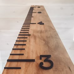 a wooden sign with numbers on it that reads 3, 5, 7 and 9