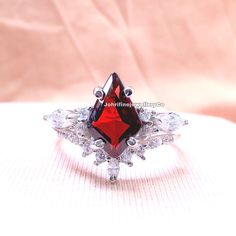 kite cut red garnet engagement ring set 14k rose gold marquise cut cubic zirconia ring for women bridal wedding ring set Specifications :- ❥ Stone - Natural Garnet  ❥ Stone Size - 7x11mm ❥ Cut Type - Kite ❥ Side stones - Simulated Diamonds Cz ❥ Ring Size: I offer more than one (Contact us if your ring size is not available in the listing) ❥ Color: Silver, Gold, Rose Gold, White Gold or Black Rhodium ❥ Material : 925 Sterling Silver, 14K/18K/22K Solid Gold --> ❥ Makes a Wonderful Gift for your Gi Red Cubic Zirconia Promise Ring, Red Cubic Zirconia Promise Ring Jewelry, Red Cubic Zirconia Jewelry For Promise Ring, Princess Cut Ruby Jewelry For Wedding, Wedding Ruby Ring With Diamond Cut Cubic Zirconia, White Gold Wedding Jewelry With Lab-created Ruby, White Gold Jewelry With Lab-created Ruby For Wedding, Cubic Zirconia Bridal Sets With Accent Stones As Gift, White Gold Lab-created Ruby Jewelry For Wedding