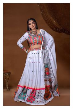 Description Introducing our White Color Muslin Cotton With Digital Print Mirror Navratri Special Lehenga Choli Made of high-quality muslin cotton, this stunning lehenga choli features a beautiful digital print and intricate mirror work, perfect for the festive season. Get ready to turn heads and make a statement with this Navratri special ensemble. About: Color White & Multi Fabric Muslin Cotton Embroidery Digital Printed Work & Real Mirror Work Chest 34 & 38 Lehenga Length 44. 5 Sleeve Length 2 Semi-stitched Bollywood Cotton Choli, Semi-stitched Cotton Lehenga With Traditional Drape, Cotton Lehenga With Resham Embroidery For Festive Occasions, Traditional Cotton Choli For Eid, Bollywood Style Semi-stitched Cotton Lehenga, Cotton Lehenga For Wedding And Eid, Bohemian Cotton Sharara For Wedding, Unstitched Cotton Lehenga With Traditional Drape, Unstitched Cotton Festive Lehenga