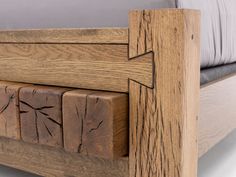 a wooden bed frame with arrows carved into the side and foot boards on each side